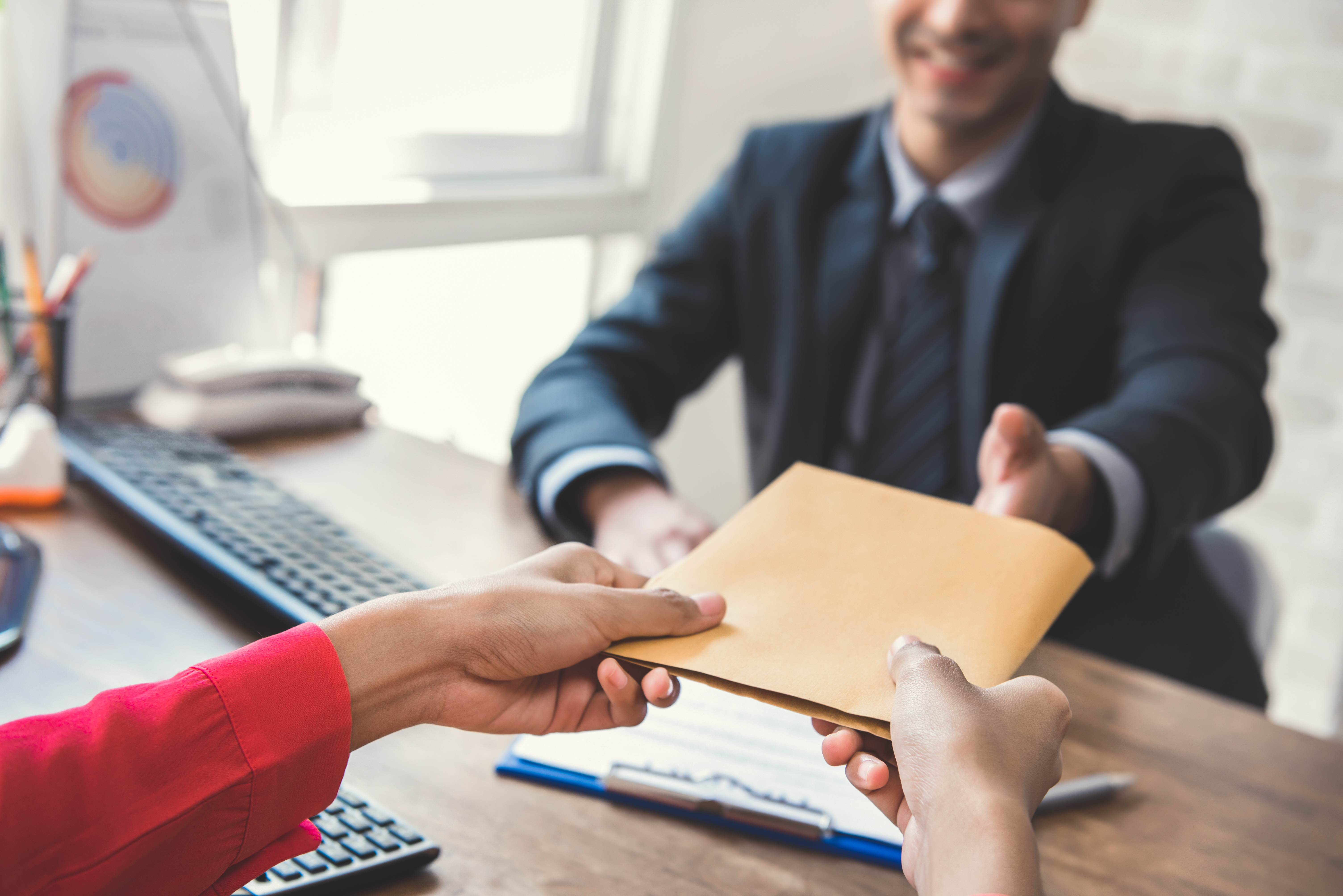 Business man handing documents to woman. Judicial Research provides the Best in Litigation support with: Printing, E Paper Discovery, Document Scanning, Indexing, Mounting, Duplication, Labeling ...